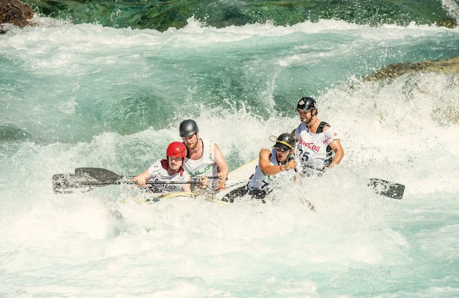 Rafters paddling through white-water rapids