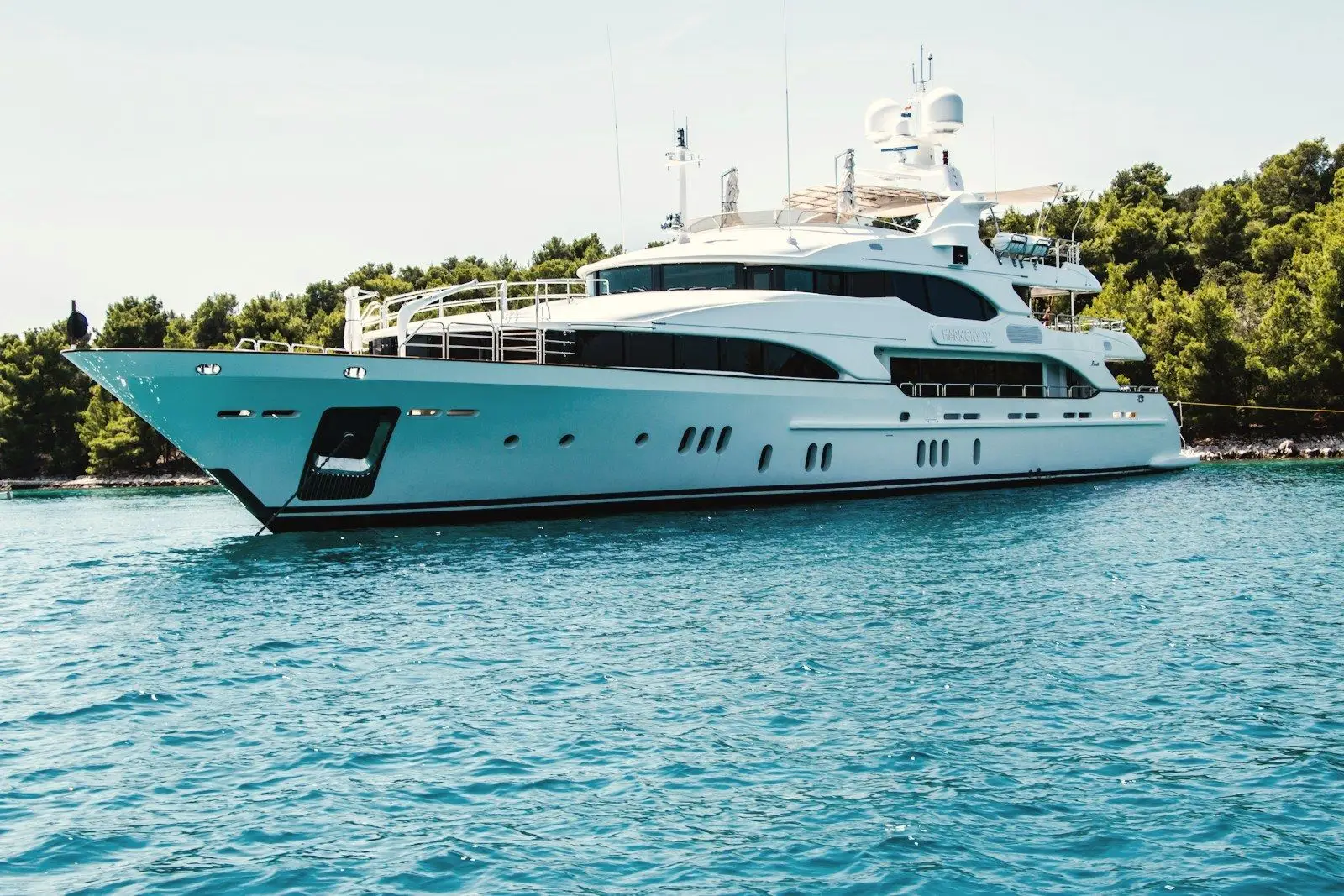 A superyacht cruising on clear blue water