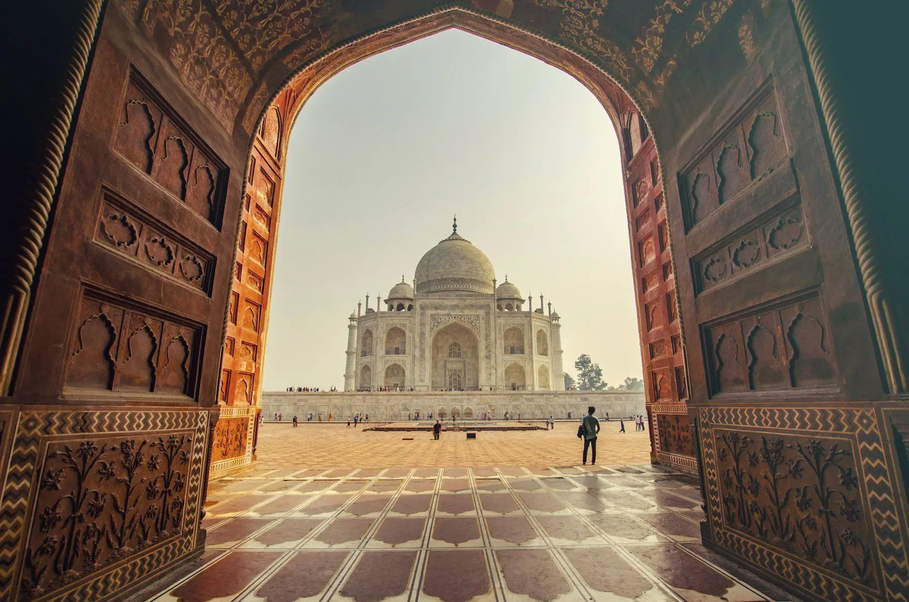 The Taj Mahal framed by a carved sandstone archway