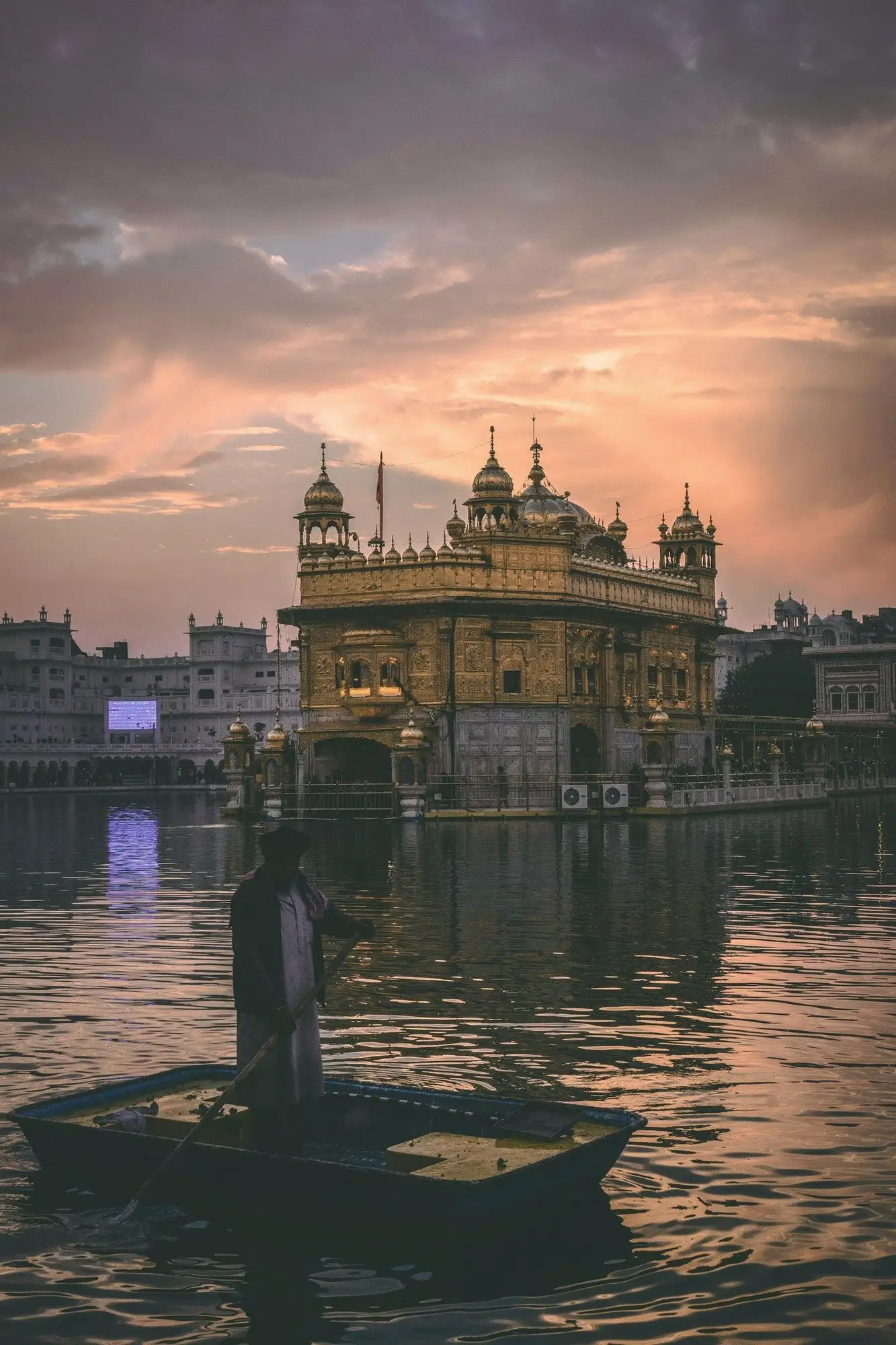 The Golden Temple glowing at dusk across its sacred pool