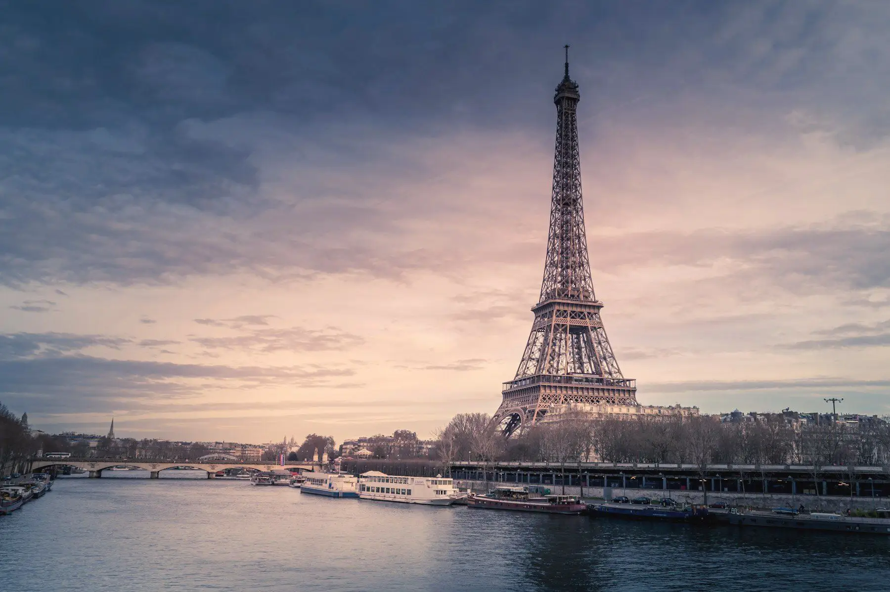 The Eiffel Tower above the Seine in soft evening light