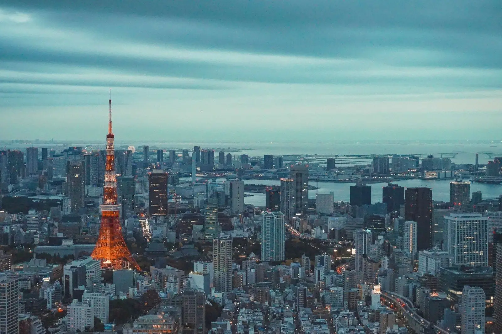 Tokyo Tower rising above the city skyline under a wide sky